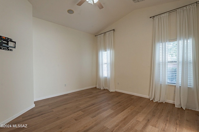 unfurnished room with ceiling fan, lofted ceiling, and light hardwood / wood-style floors