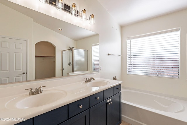 bathroom featuring vanity, lofted ceiling, and shower with separate bathtub