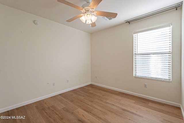 spare room featuring ceiling fan and light wood-type flooring