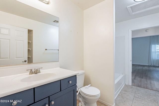 bathroom with tile patterned flooring, vanity, and toilet