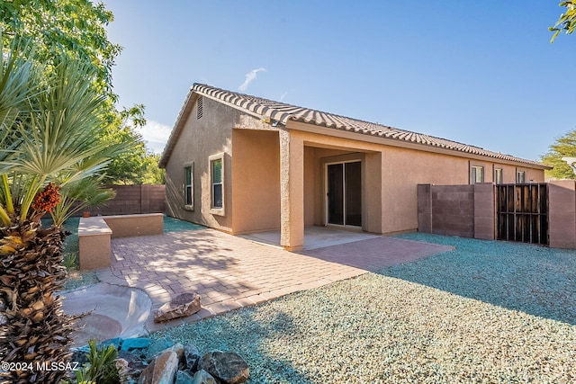 rear view of house featuring a patio