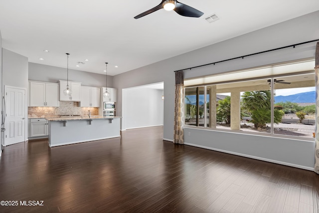 60241 E Arroyo Grande Dr, Oracle, AZ 85623 - unfurnished living room with a ceiling fan, recessed lighting, baseboards, dark wood-style flooring, and a sink