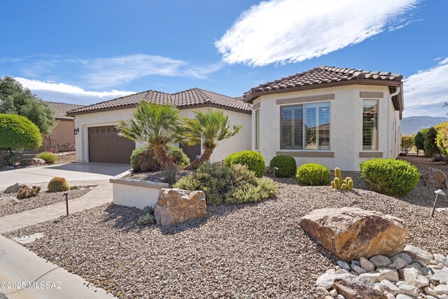 60241 E Arroyo Grande Dr, Oracle, AZ 85623 - mediterranean / spanish-style house featuring a garage, concrete driveway, stucco siding, and a tile roof