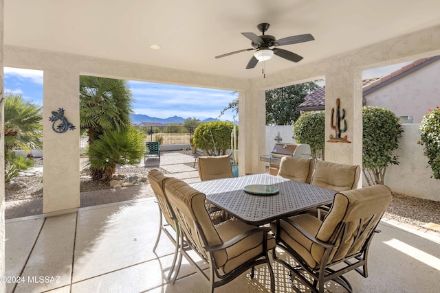 60241 E Arroyo Grande Dr, Oracle, AZ 85623 - view of patio with a ceiling fan, a mountain view, fence, and outdoor dining space