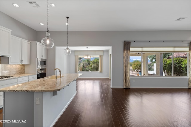 60241 E Arroyo Grande Dr, Oracle, AZ 85623 - kitchen with appliances with stainless steel finishes, a sink, white cabinetry, light stone countertops, and recessed lighting