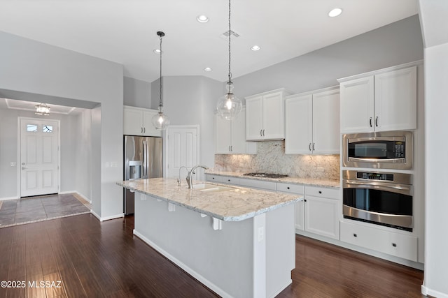 60241 E Arroyo Grande Dr, Oracle, AZ 85623 - kitchen featuring appliances with stainless steel finishes, a sink, light stone counters, dark wood-type flooring, and white cabinetry
