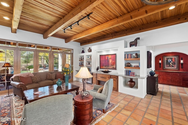 living room featuring french doors, light tile patterned flooring, track lighting, wood ceiling, and beam ceiling