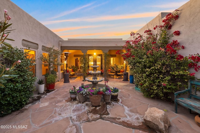 view of patio terrace at dusk