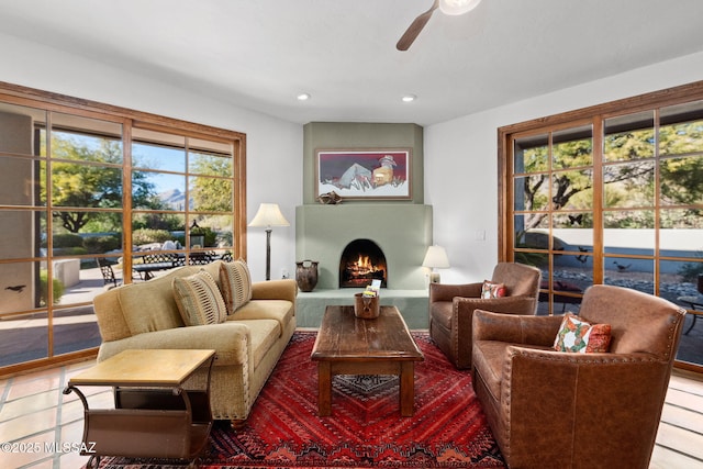 living area featuring tile patterned flooring and ceiling fan