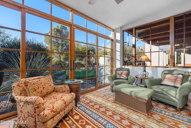 sunroom / solarium featuring ceiling fan