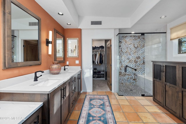 bathroom featuring vanity, tile patterned flooring, and walk in shower