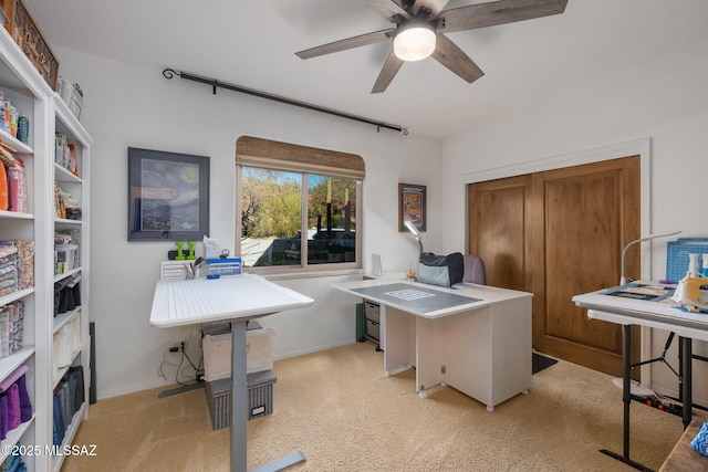 home office featuring light colored carpet and ceiling fan