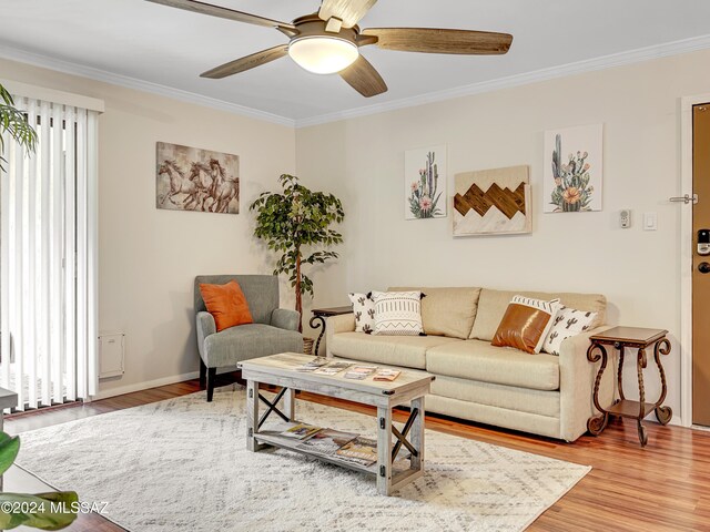 living room with crown molding, ceiling fan, and hardwood / wood-style flooring