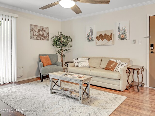 living room with hardwood / wood-style flooring, ceiling fan, and ornamental molding