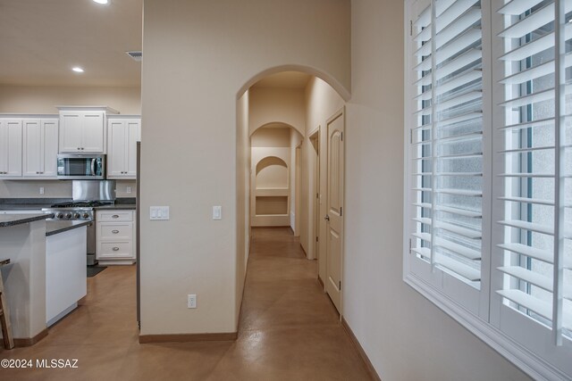 kitchen featuring dark stone countertops, white cabinets, and appliances with stainless steel finishes