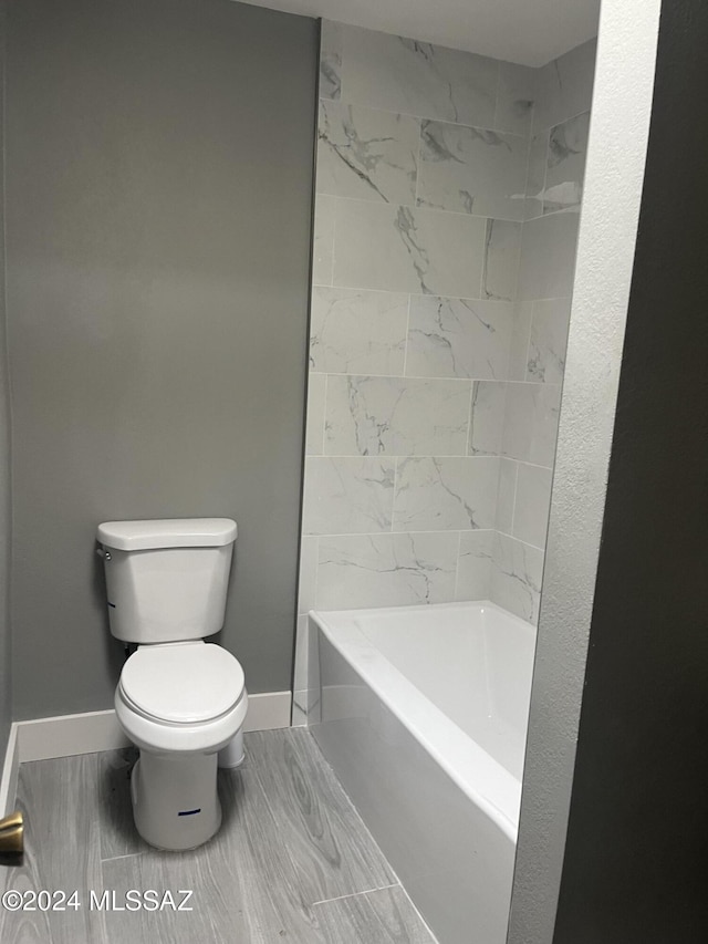 bathroom featuring toilet and shower / washtub combination