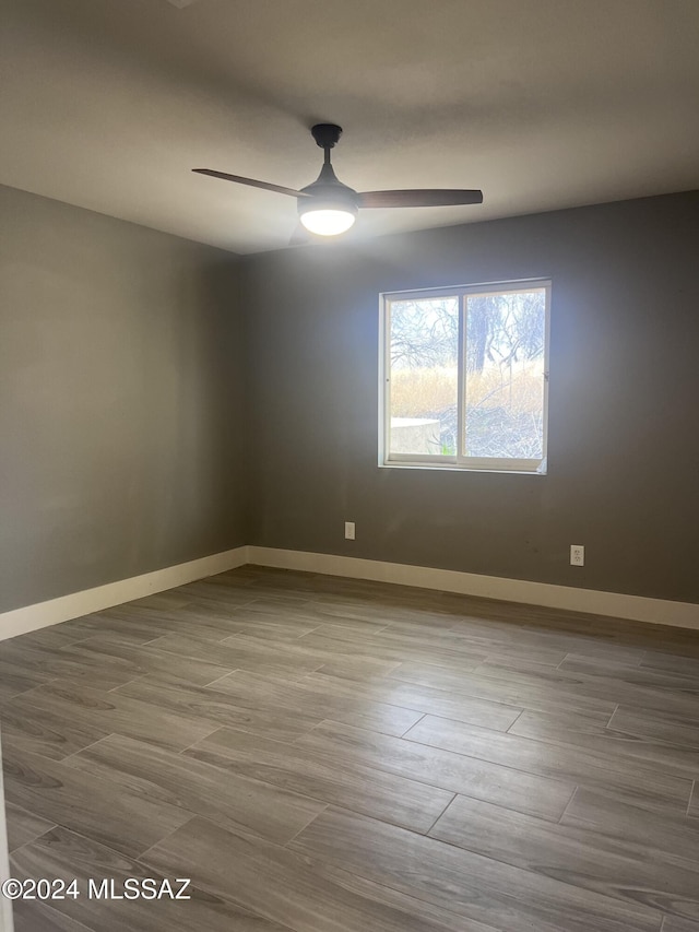 unfurnished room featuring hardwood / wood-style floors and ceiling fan