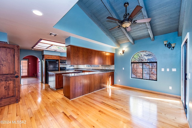 kitchen with kitchen peninsula, light hardwood / wood-style flooring, beamed ceiling, and wooden ceiling