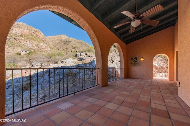 view of patio / terrace featuring ceiling fan, a balcony, and a mountain view