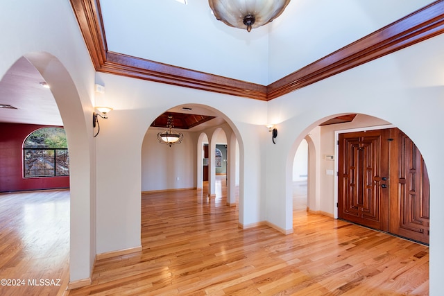 entrance foyer featuring light wood-type flooring and ornamental molding