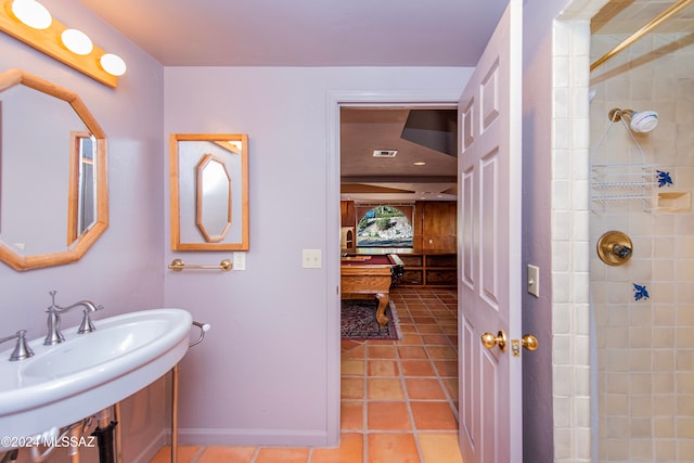 bathroom with a tile shower, tile patterned floors, sink, and billiards