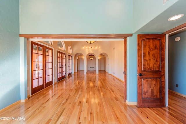 spare room featuring light hardwood / wood-style flooring and french doors