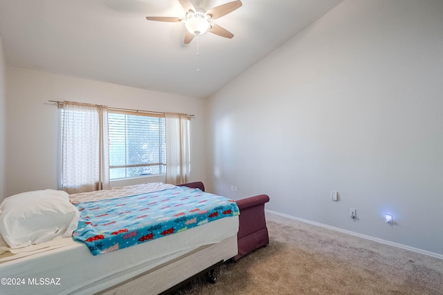 carpeted bedroom with ceiling fan, baseboards, and vaulted ceiling