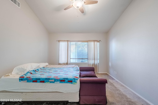 carpeted bedroom featuring baseboards, visible vents, vaulted ceiling, and a ceiling fan