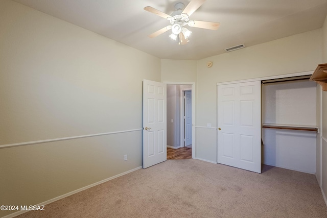 unfurnished bedroom with ceiling fan, carpet floors, visible vents, baseboards, and a closet