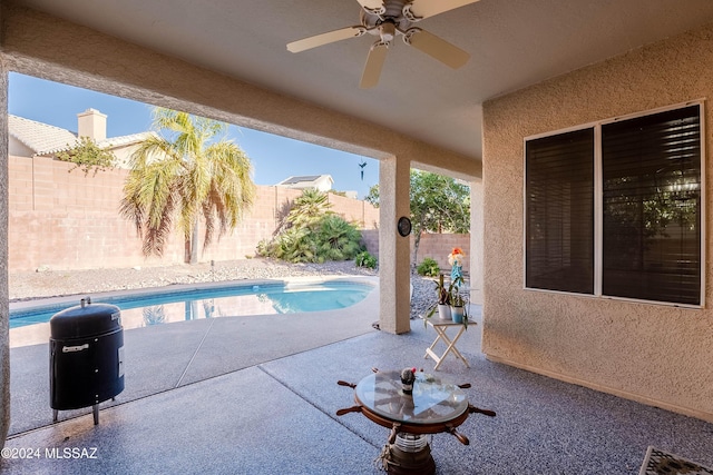 view of swimming pool featuring a patio area, a fenced backyard, ceiling fan, and a fenced in pool