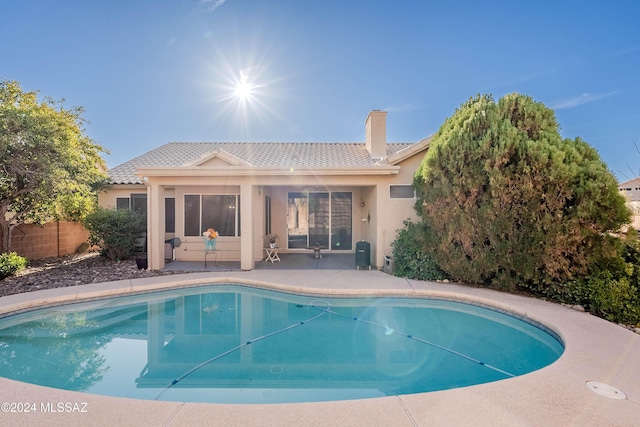 view of swimming pool featuring a patio area, fence, and a fenced in pool