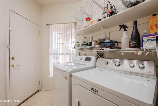 laundry room with laundry area, light floors, and washing machine and dryer