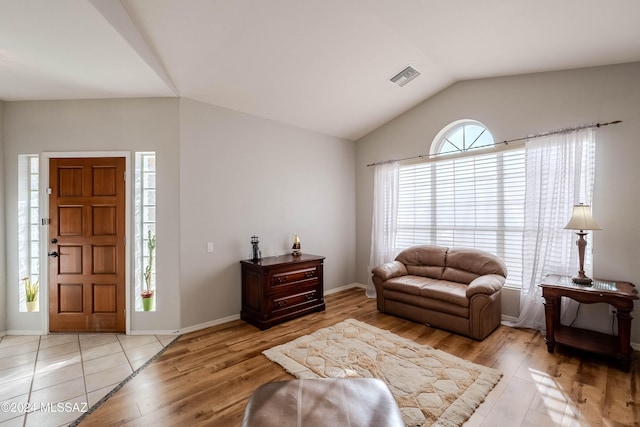 living room with lofted ceiling and light wood-type flooring