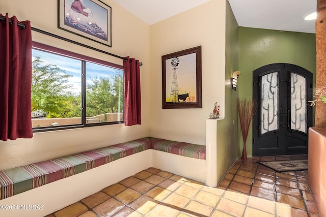 foyer featuring french doors and light tile patterned flooring