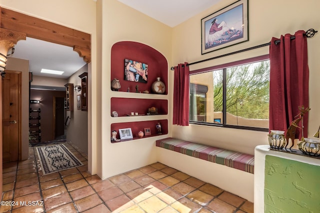 hall featuring light tile patterned flooring