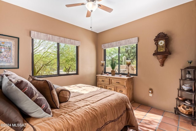 tiled bedroom featuring ceiling fan