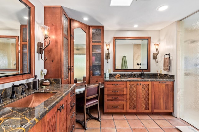 bathroom featuring an enclosed shower, vanity, and tile patterned flooring