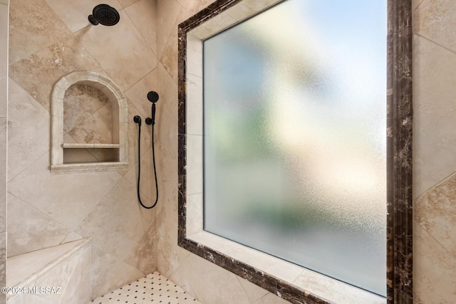 bathroom with a tile shower