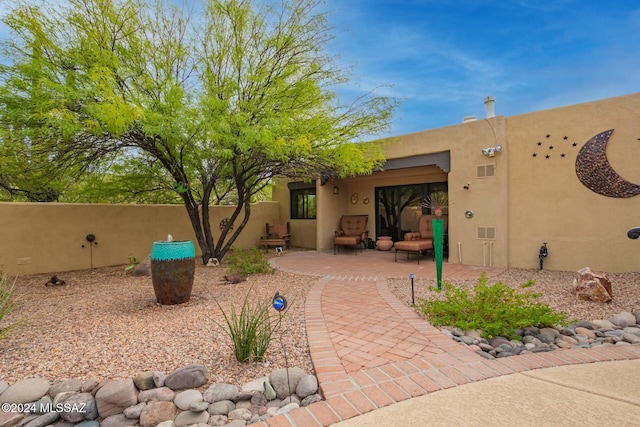 back of property with a patio