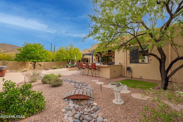 view of yard with a patio, an outdoor kitchen, and a bar