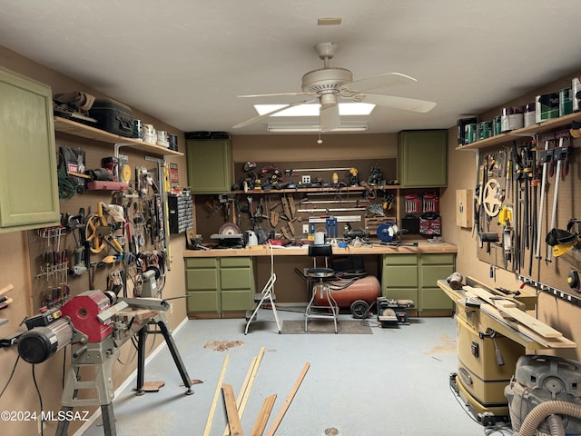 miscellaneous room with ceiling fan and a workshop area