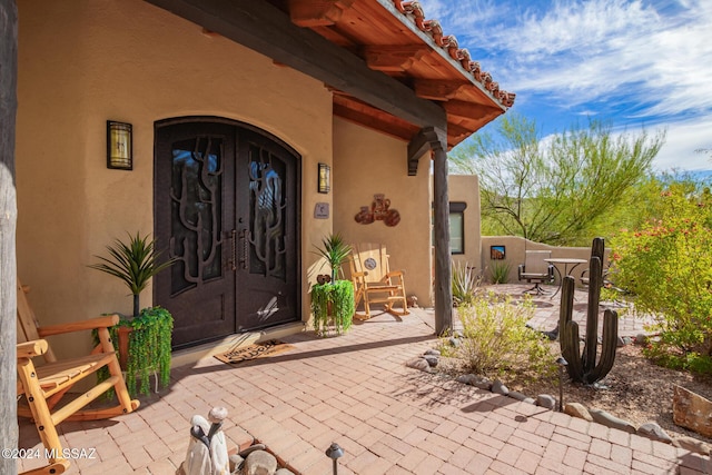 doorway to property featuring a patio area and french doors