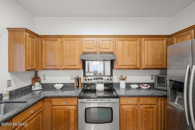 kitchen with dark stone countertops, sink, and stainless steel appliances