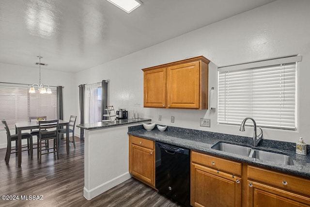 kitchen with dishwasher, sink, hanging light fixtures, dark hardwood / wood-style floors, and dark stone countertops