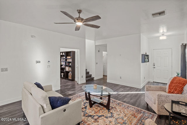 living room with dark hardwood / wood-style floors and ceiling fan