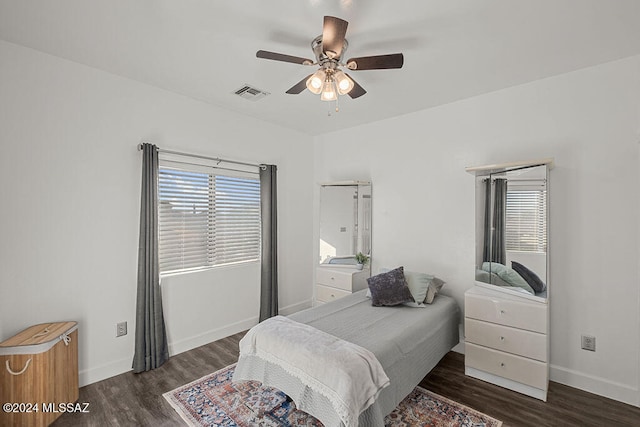 bedroom with ceiling fan and dark wood-type flooring