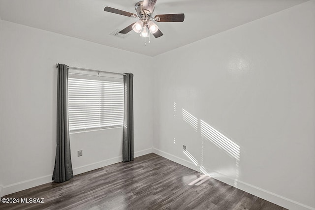 spare room featuring ceiling fan and dark wood-type flooring