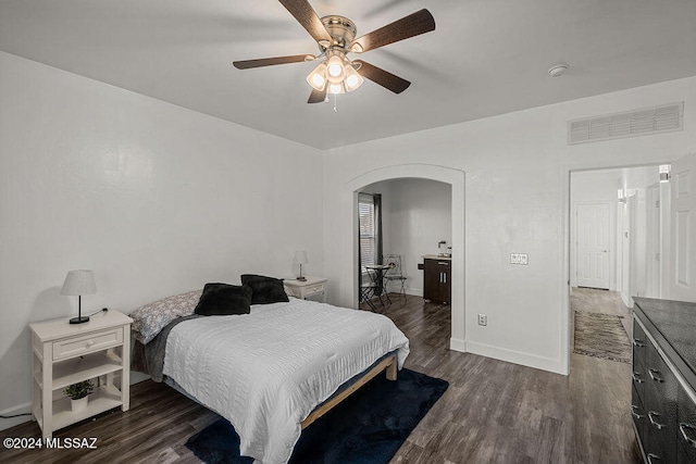 bedroom with dark hardwood / wood-style floors and ceiling fan