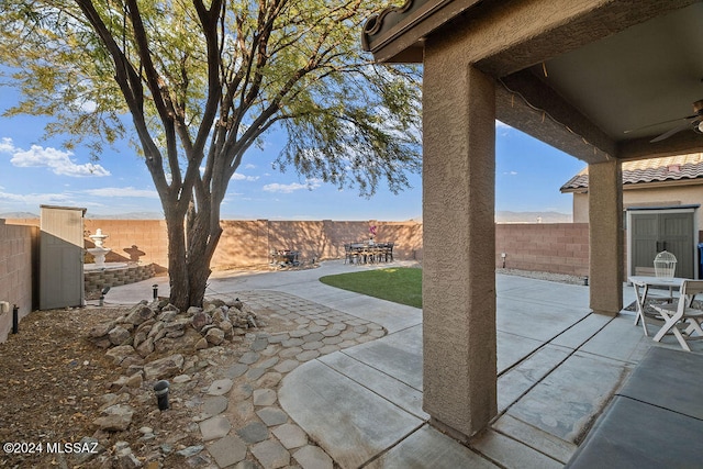 view of patio / terrace featuring a mountain view and ceiling fan