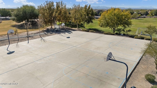 view of patio / terrace with a mountain view and basketball hoop